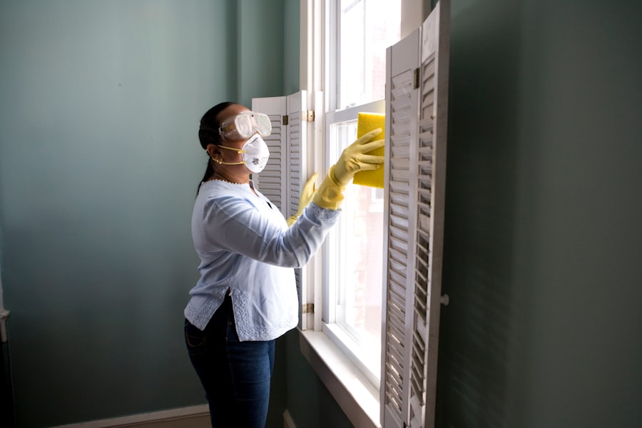 Professional cleaner wiping interior window shutters